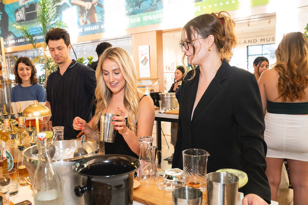 Two ladies making cocktails together